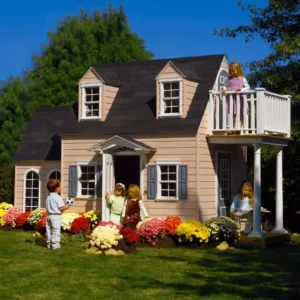 Children playing around the Cotton Candy Manor, a charming pink two-story playhouse nestled in a garden bursting with colorful flowers.