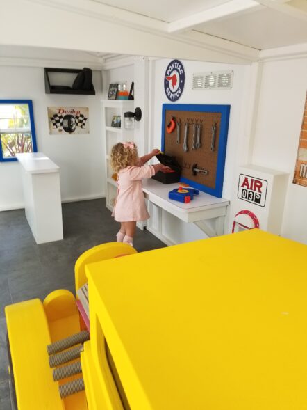 Child playing in Service Station play house