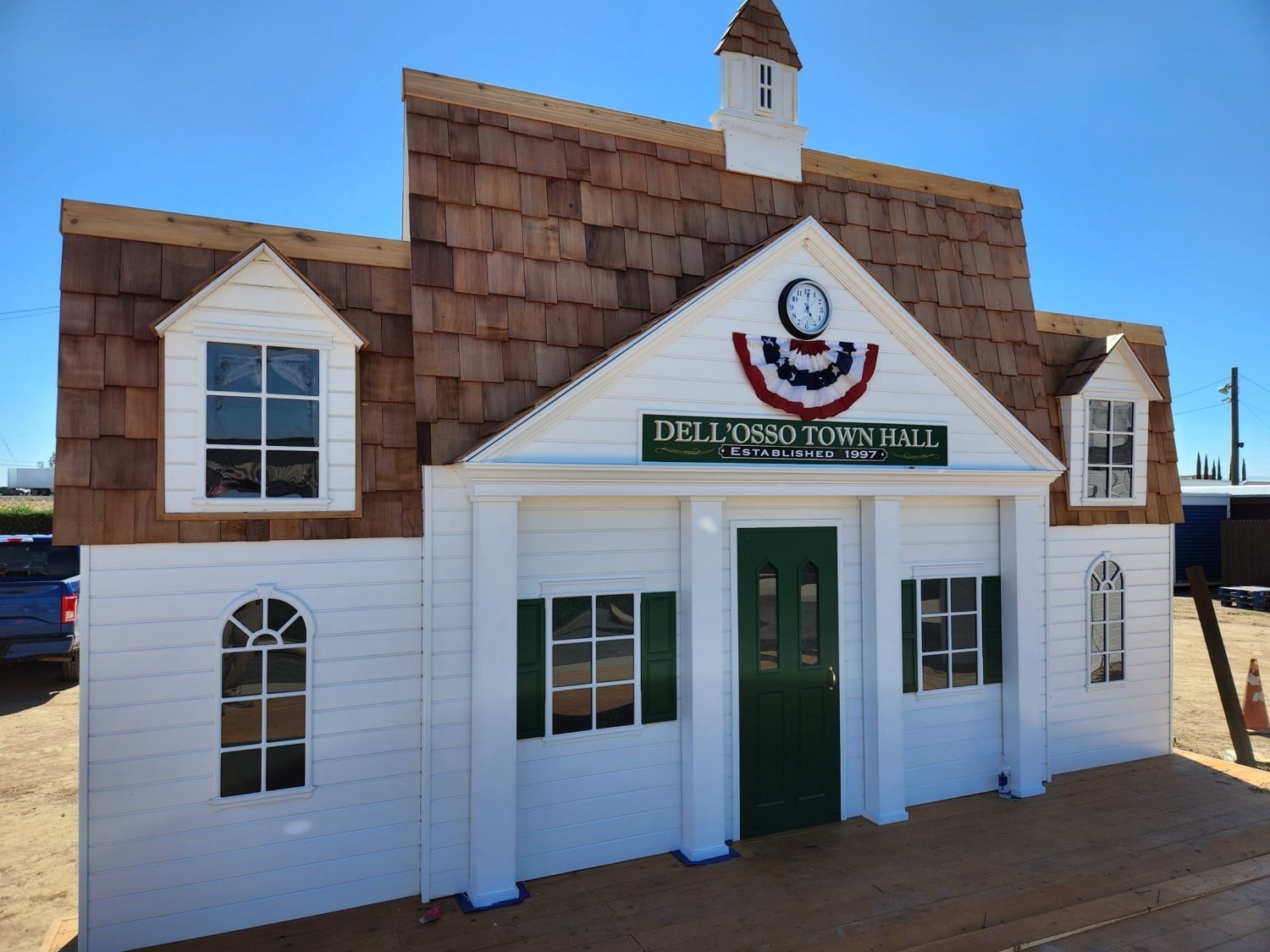 A child sized Town Hall building with red, white, and blue bunting on the front.
