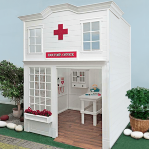 Indoor Main Street Doctors Office playhouse, featuring a child-sized operation table, AED, and cabinet for doctor's tool toys inside.
