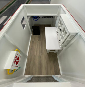 Top view of ambulance playhouse with AED and surgical table in view