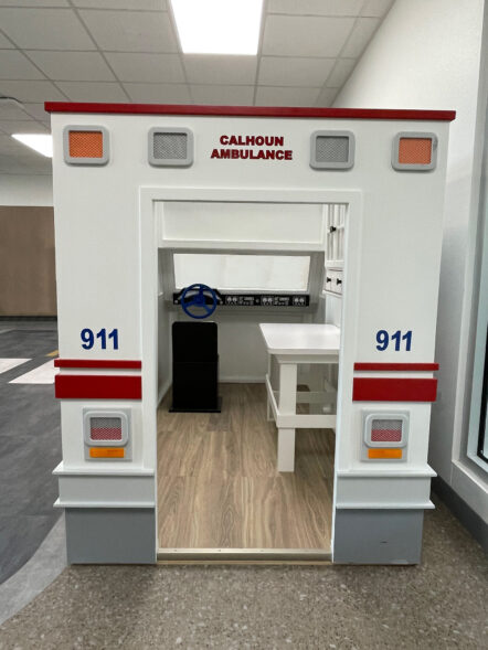 Back view of Ambulance playhouse with drivers seat and operation table in view
