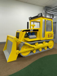 Side view of Little Buddy Bulldozer inside a play center
