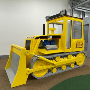 Side view of Little Buddy Bulldozer inside a play center
