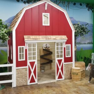 Lilliput's Barn playhouse with an Egg Drop Feature inside and a riding horse outside, in place as part of a large commercial play center in a mall in Ecuador.