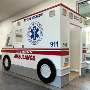 A pretend play ambulance, with Calhoun Ambulance written on the side.
