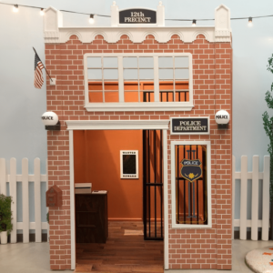 A police department playhouse with a red brick facade, jail cell wanted poster and counter enable great pretend play.