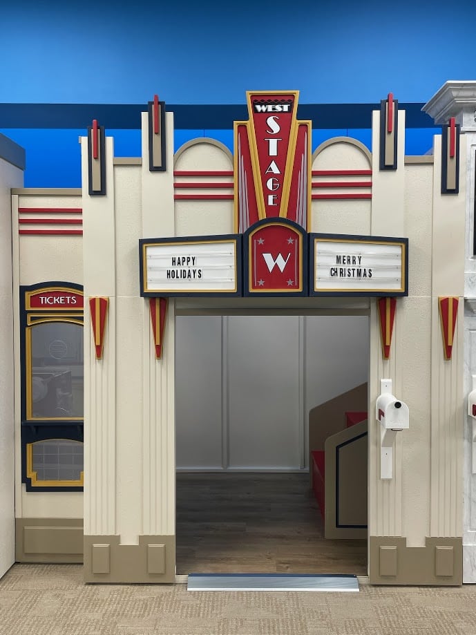 The Main Street Theater playhouse with its decorative marque is ready for children to put on their best pretend play performance.
