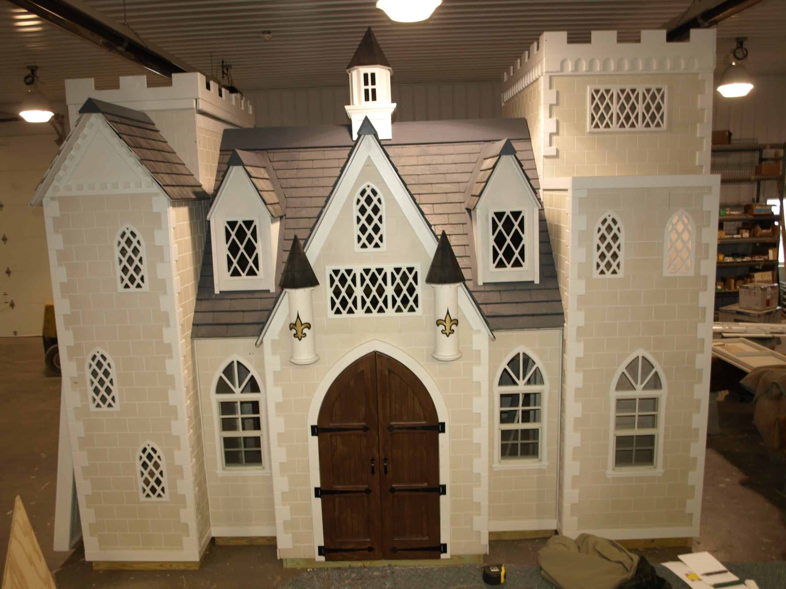 A small, detailed castle with multiple towers and arched windows.