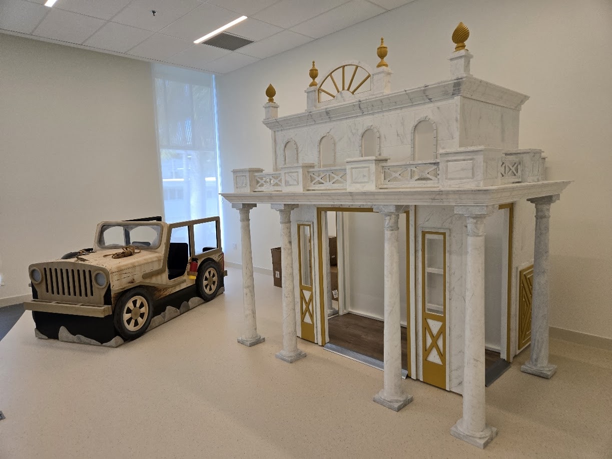 A custom temple play house, with a desert jeep sitting nearby.
