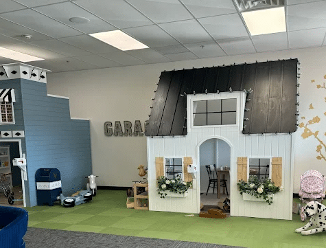 A long shot image of Nana's House on Main Street playhouse among an indoor play village.