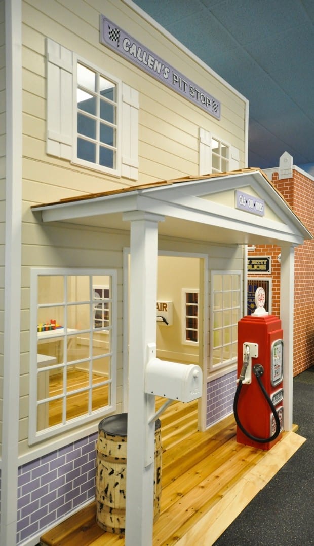 Country Roads Gas Station children's play area features a vintage gas station theme with a red gas pump, mailbox, wooden barrel, and a "Callens Pit Stop" sign above the entrance.